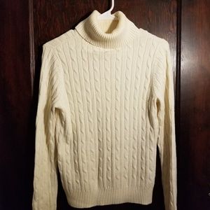 Cream cable knit turtleneck sweater.